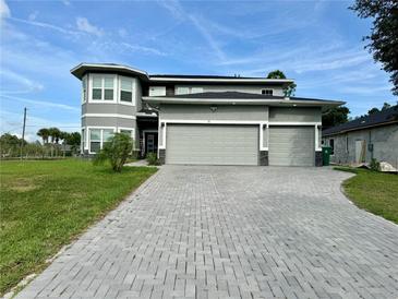 Beautiful two-story home featuring a spacious three-car garage and a well-manicured front yard at 22223 Seyburn Ter, Port Charlotte, FL 33954
