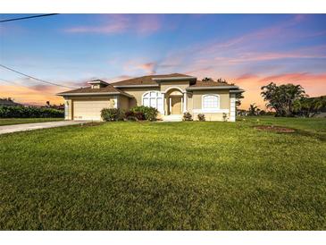 Charming single-story home with a lush green lawn and well-maintained landscaping at 235 Tournament Rd, Rotonda West, FL 33947