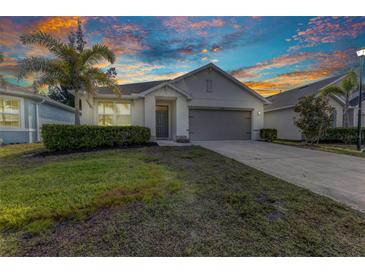Charming single-story home featuring well-kept landscaping, palm tree, and a two-car garage at 25340 E Lenox Cir, Punta Gorda, FL 33950