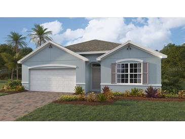 Charming single-story home featuring a brick driveway, attached garage, and lush landscaping at 9510 Turtle Grass Cir, Punta Gorda, FL 33950