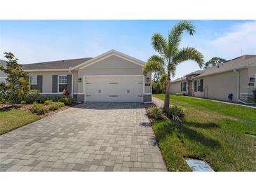 Charming one-story home featuring a spacious two-car garage and a beautifully paved driveway at 1796 W Palms Dr, Port Charlotte, FL 33953
