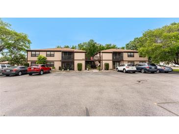 Exterior view of a well-maintained condo with a balcony and ample parking at 4022 Beaver Ln # 500C, Port Charlotte, FL 33952