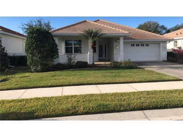 Charming single-story home with a well-manicured lawn and attached two-car garage in a sunny neighborhood at 6379 Grand Cypress Blvd, North Port, FL 34287