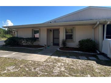 Charming single-story home featuring lush landscaping, a cozy entryway, and a well-maintained lawn at 25068 Harborview Rd # 3D, Punta Gorda, FL 33980