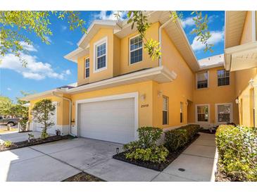 Charming two-story home with a well-maintained lawn, a two-car garage, and beautiful landscaping at 25559 Heritage Lake Blvd # 25, Punta Gorda, FL 33983