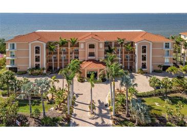 Beautiful building with a red tile roof, lush landscaping, and stunning ocean views at 95 N Marion Ct # 126, Punta Gorda, FL 33950