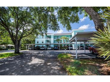 Condominium with assigned covered parking and tropical landscaping at 19385 Water Oak Dr # 302, Port Charlotte, FL 33948