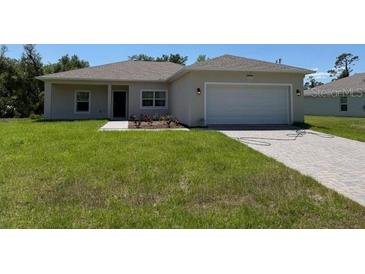 Charming single-story home with a well-maintained lawn and a two-car garage at 20241 Lorette Ave, Port Charlotte, FL 33954