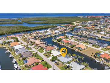 Stunning aerial view of waterfront homes with boat docks and lush landscaping in a desirable coastal community at 2718 Saint Thomas Dr, Punta Gorda, FL 33950