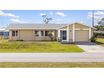 Charming single-story home with a well-maintained lawn and attached garage, perfect for suburban living at 558 Azalea Drive, Port Charlotte, FL 33952