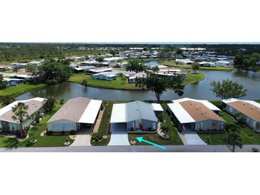 A waterfront home with lush landscaping and community lake views in a peaceful 55+ neighborhood at 749 Watersedge St, Englewood, FL 34223