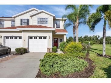 Inviting two-story home with well-manicured landscaping and attached two-car garage at 1085 Jonah Dr, North Port, FL 34289