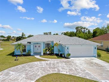 Charming single-story home featuring a well-manicured lawn, circular driveway, and a two-car garage at 1140 Capricorn Blvd, Punta Gorda, FL 33983