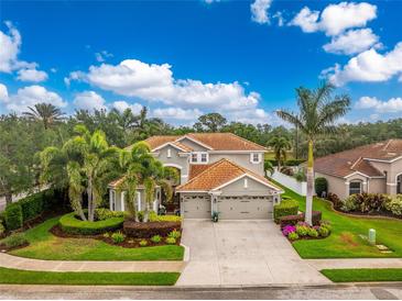 Beautiful home with a three-car garage, beautiful landscaping, and a tile roof at 1814 Pinyon Pine Dr, Sarasota, FL 34240