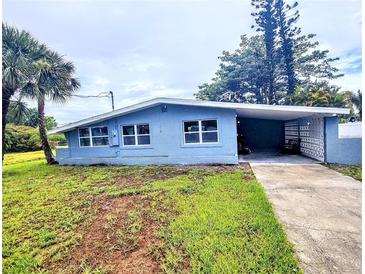 Charming single-story home with a covered carport and well-maintained landscaping on a partially cloudy day at 190 Danforth Dr, Punta Gorda, FL 33980