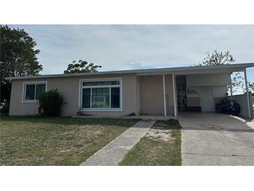 Charming single-story home features a welcoming entryway and covered parking at 22191 Augusta Ave, Port Charlotte, FL 33952