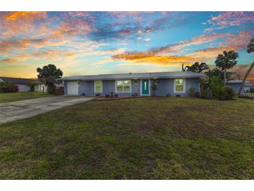 Charming one-story home with well-maintained lawn, lush landscaping, and updated exterior paint at 2236 Arnet St, Port Charlotte, FL 33948