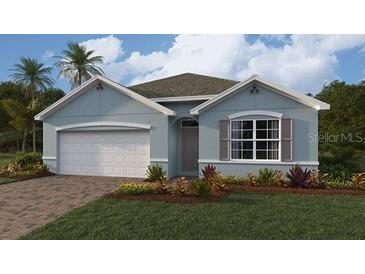 Charming single-story home with a two-car garage, manicured lawn, and beautiful landscaping at 15264 Buswell Ave, Port Charlotte, FL 33953
