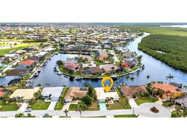 Stunning aerial view of waterfront homes with boat docks and access to a beautiful canal system at 3824 Aves Island Ct, Punta Gorda, FL 33950