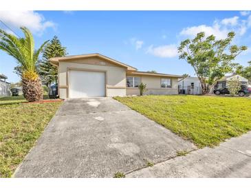 Charming single-story home with a well-maintained lawn and a white garage door at 8172 Trionfo Ave, North Port, FL 34287
