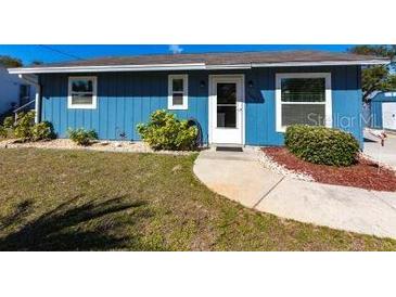 Charming single-story home with light blue siding, a well-maintained lawn, and fresh landscaping at 3249 Cedarbrook Dr, Punta Gorda, FL 33982