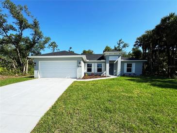 Charming single-Gathering home features a well-manicured lawn and attached two-car garage at 6346 Lachine Ave, North Port, FL 34291