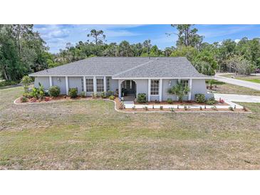 Charming single-story home with well-maintained landscaping and a lush green lawn at 1556 Eagle St, Port Charlotte, FL 33952