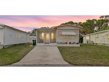 Charming single-Gathering home featuring a screened porch and awning-covered windows at 5488 Holiday Park Blvd, North Port, FL 34287