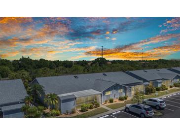 Low aerial view of condo community against colorful dusk sky at 3300 Loveland Blvd # 2801, Punta Gorda, FL 33980