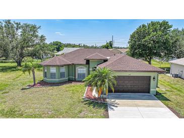 Inviting single-story home showcasing a well-manicured lawn and charming front yard landscaping at 347 Casale G St, Punta Gorda, FL 33983