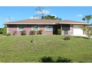 Charming single-story home with a well-maintained lawn and a clean, inviting exterior at 582 Reading Nw St, Port Charlotte, FL 33952