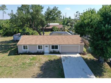 Charming single-story home with a well-manicured lawn and attached one car garage at 18459 Inwood Ave, Port Charlotte, FL 33948