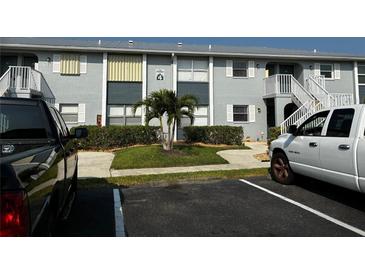 Condo building with lush landscaping, open stairwells and updated exterior paint at 25050 Sandhill Blvd # B3, Punta Gorda, FL 33983