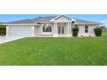 Charming single-story home featuring a well-manicured lawn and attached two-car garage at 2531 Pebble Creek Pl, Port Charlotte, FL 33948