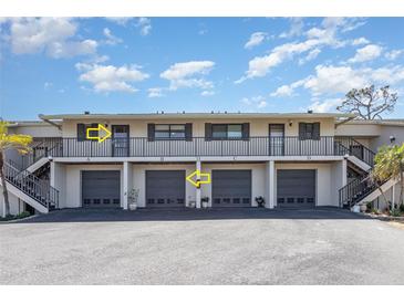 Attractive two-story condo building with private entrances and covered parking spots at 4260 Placida Rd # 13B, Englewood, FL 34224