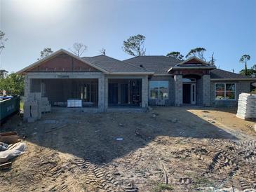 New construction home featuring a modern design with a sturdy block foundation and dark roof at 47 Tee View Rd, Rotonda West, FL 33947