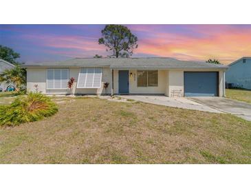 Charming single-story home featuring a blue front door and a one-car garage at 8238 San Jacinto Ave, North Port, FL 34287