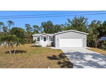 Charming single-Gathering home featuring a spacious front yard and a two-car garage at 11136 Grapefruit Ln, Punta Gorda, FL 33955