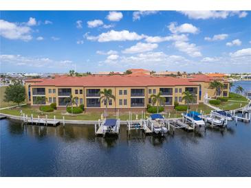 Waterfront condo featuring boat slips, lush landscaping, and stunning views at 3334 Purple Martin Dr # 214, Punta Gorda, FL 33950