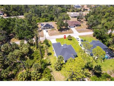 Beautiful aerial view of a home with lush landscaping and a spacious yard at 4880 Cornsilk Ter, North Port, FL 34286