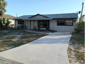 Charming single-story home with a well-maintained lawn and a concrete driveway leading up to the front entrance at 7321 Bolten Ln, Port Charlotte, FL 33981