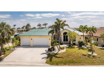 Charming single-Gathering home with lush landscaping, a spacious driveway, and a two-car garage at 1134 Coronado Dr, Punta Gorda, FL 33950