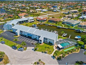 Waterfront property featuring canal access, boat docks, community pool and beautifully maintained landscaping at 1318 Wesley Dr # 7, Punta Gorda, FL 33950
