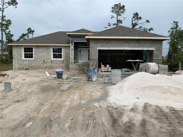 New construction home featuring a modern design with a spacious open garage at 139 Hardee Way, Rotonda West, FL 33947