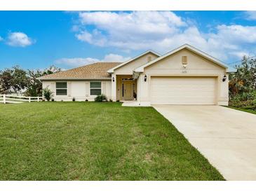 Charming single-story home with well-manicured lawn, neutral exterior, and a two-car garage at 1690 Yakutat Rd, North Port, FL 34287