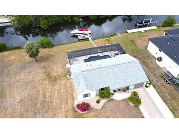 Stunning waterfront home featuring a screened pool, boat dock and a well maintained yard in a desirable location at 18954 Ayrshire Cir, Port Charlotte, FL 33948