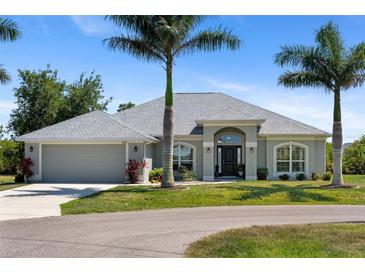 Charming single story home featuring beautiful landscaping and a two-car garage at 27147 Guapore Dr, Punta Gorda, FL 33983