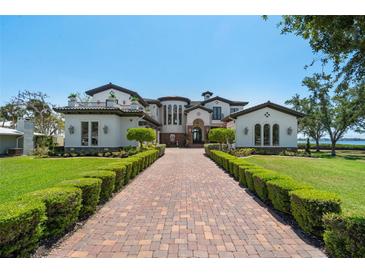 Stunning estate featuring a long brick driveway and meticulously manicured landscaping at 2107 4Th Street W Ct, Palmetto, FL 34221