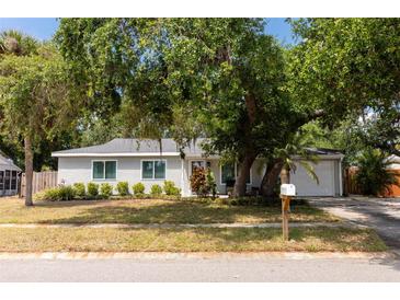 Charming single-story home featuring a well-maintained lawn and beautiful mature trees at 5333 Simrak St, North Port, FL 34287