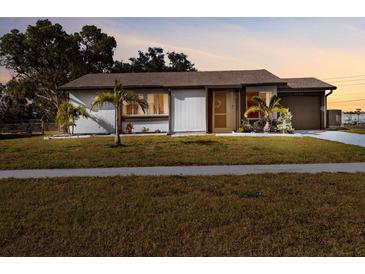 Charming single-story home with well-maintained lawn and tidy landscaping, creating great curb appeal at 5520 Kenwood Dr, North Port, FL 34287
